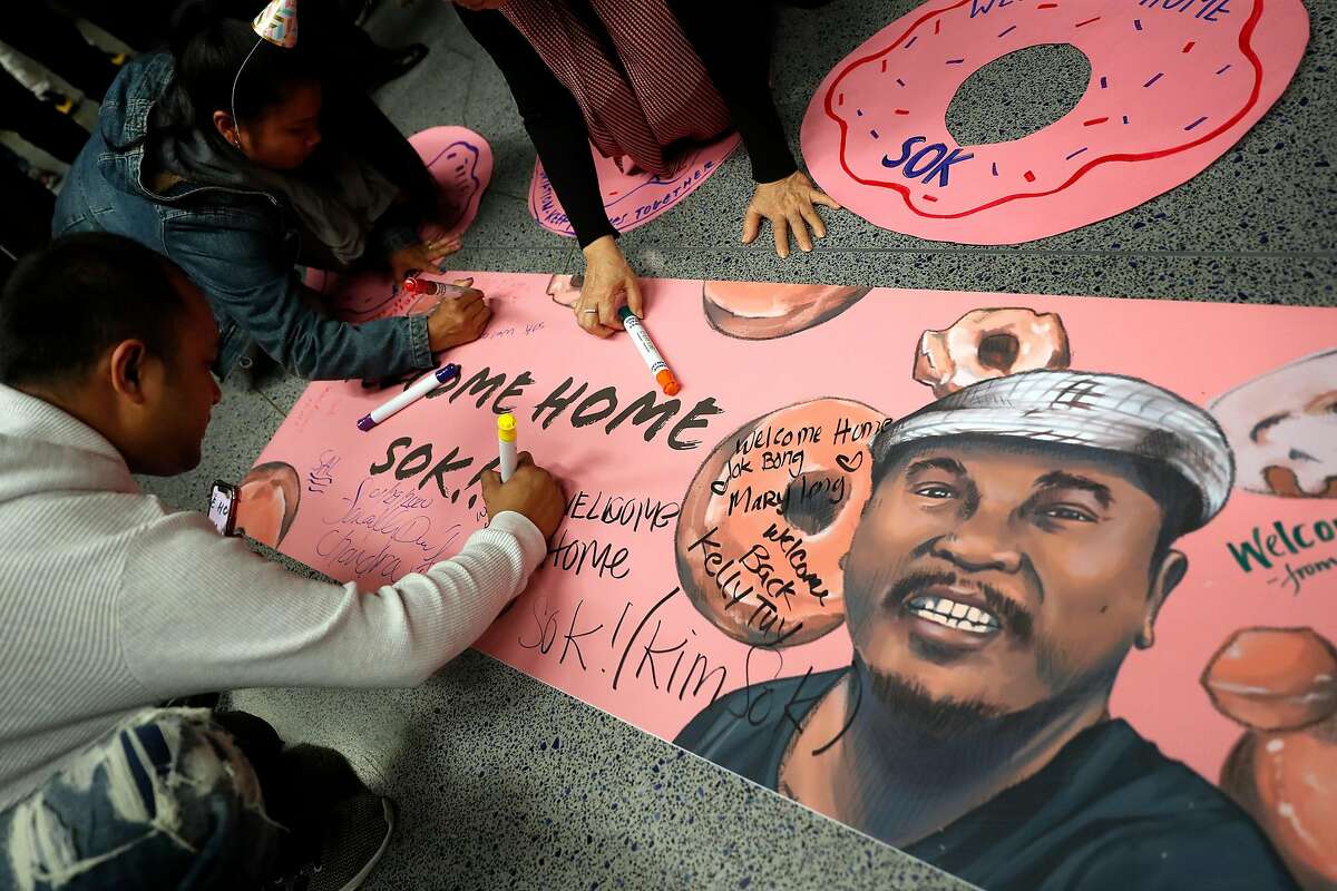 People sign a Welcome Home banner before Sok Loeun arrived at SFO International Terminal in San Francisco, Calif., on Wednesday, January 29, 2020. Sok Leon was deported to Cambodia 5 years ago.