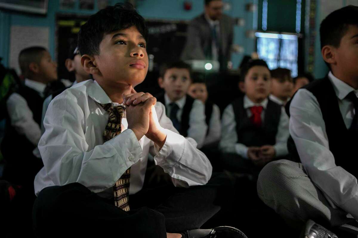 Adrian Landino, 9, intently listens to a speaker during an after-school meeting of Caballeros Distinguidos, a boys-only etiquette club at Briscoe Elementary School. The boys wear dress clothes, practice handshakes and learn table manners and other etiquette rules.