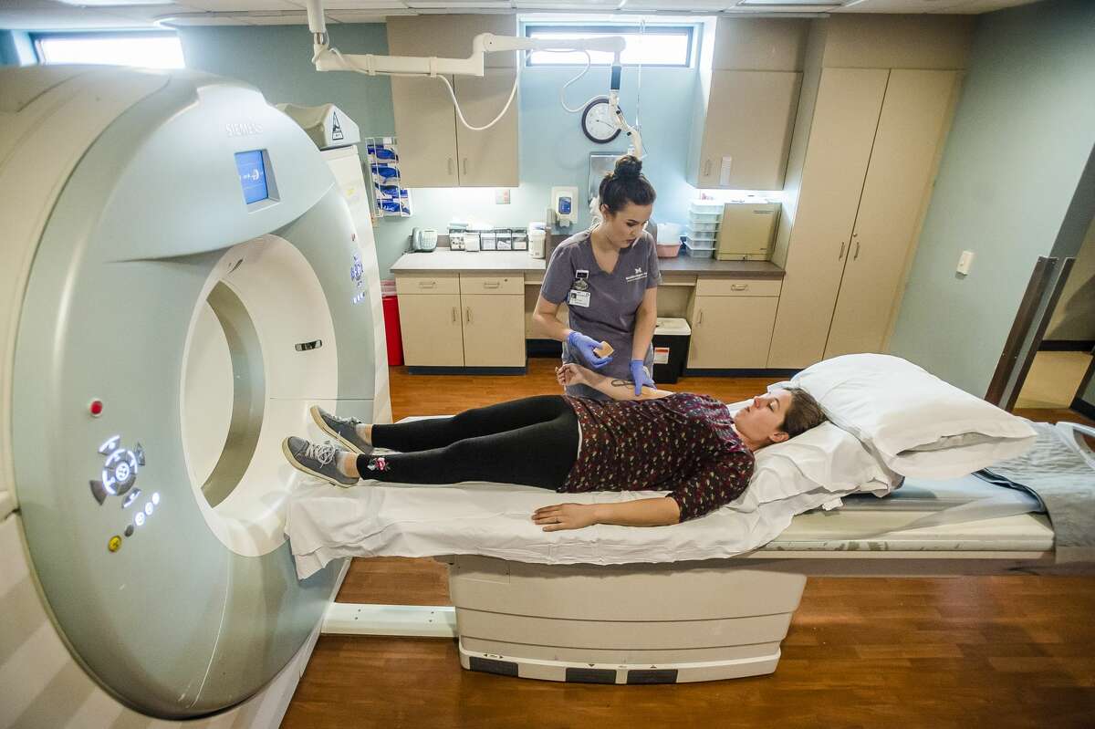 Autumn Brown, a CT scan technologist, prepares Tasha Earegood for a CT scan Tuesday, Oct. 22, 2019 at MidMichigan Medical Center-Midland. Tasha has regular scans to monitor her progress while undergoing treatment. (Katy Kildee/kkildee@mdn.net)