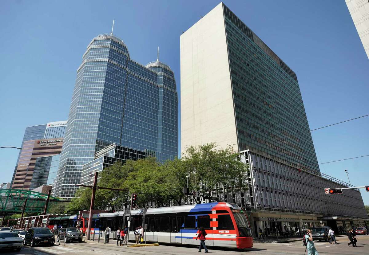 A Metropolitan Transit Authority train passes by The Medical Towers at Fannin and Dryden on March 26, 2019, in Houston.