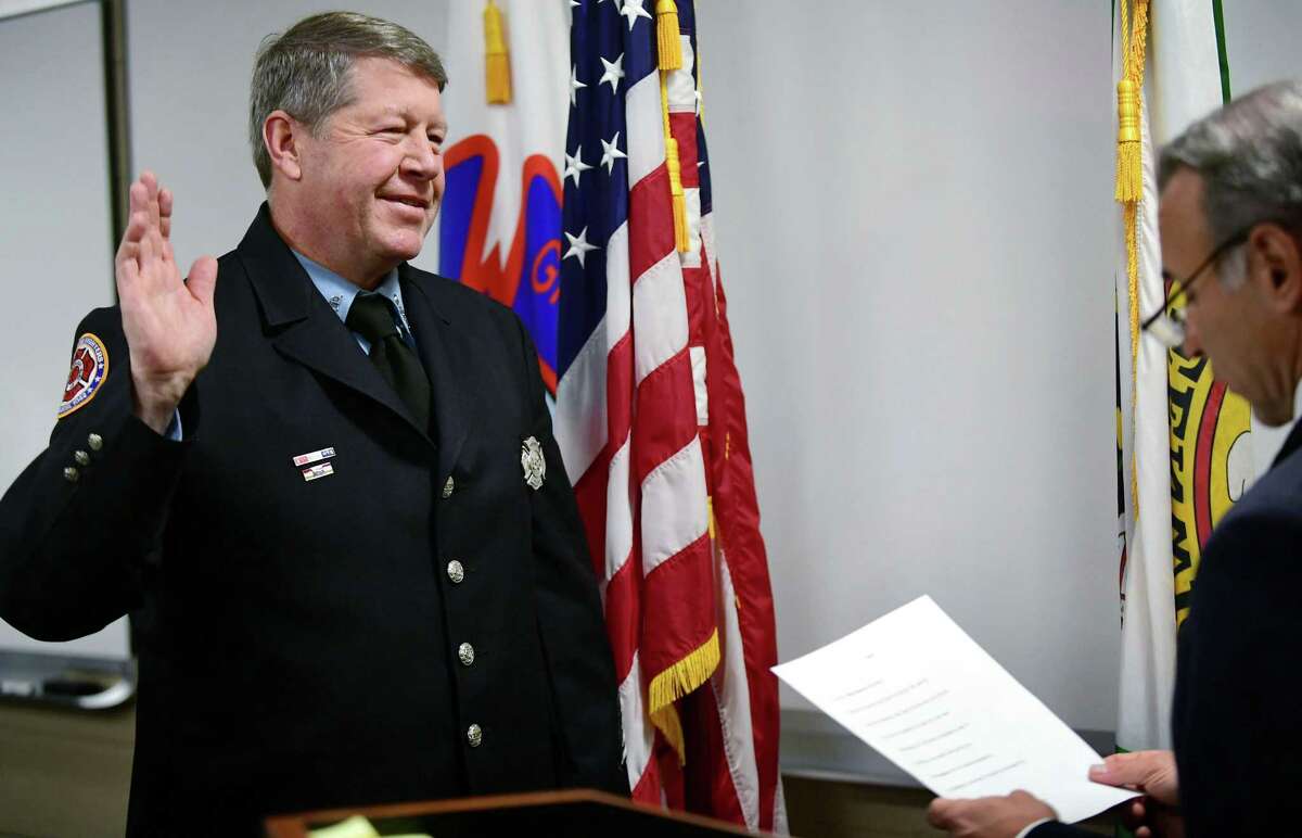 Firefighter Mark Dawson is sworn in as Fire Marshal by First Selectmen Fred Camillo during a brief ceremony Friday, January 31, 2020, at the Central Fire Station in Greenwich, Conn.