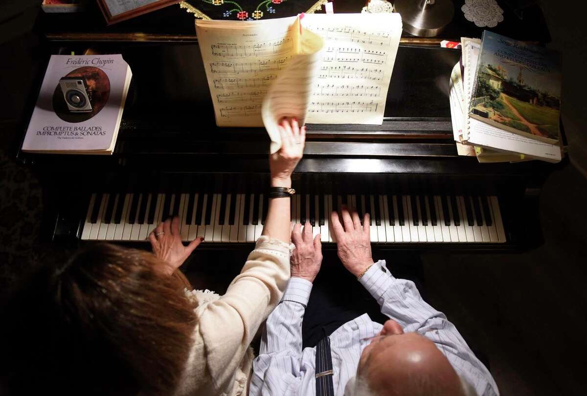 Above, Howard Aibel and Mimi Melkonian play piano in their Cos Cob home. Aibel, also pictured left, has toured around the world.