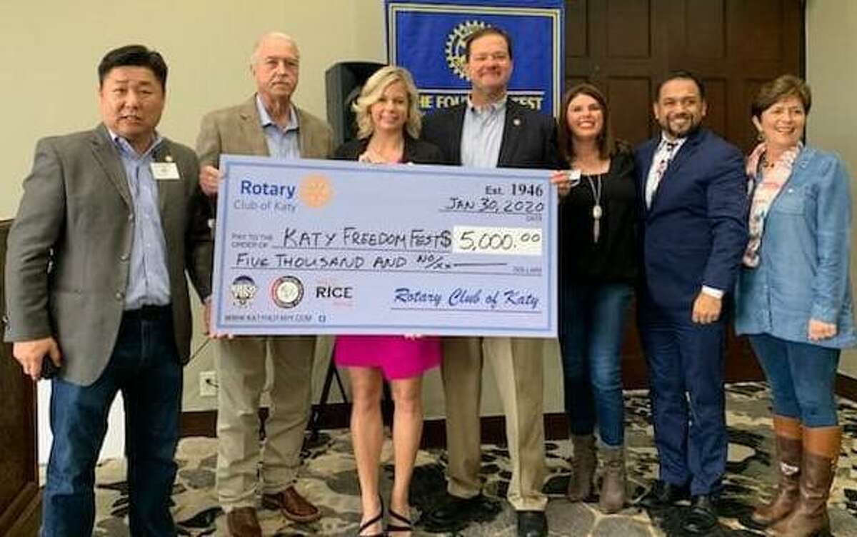 The Rotary Club of Katy presented a check to city officials for their Freedom Fest. From left are Scotty Jung, Bill Hastings, Kayce Reina, Byron Herbert, Heather Schuren, Eric San Miguel and Julie Sawyer