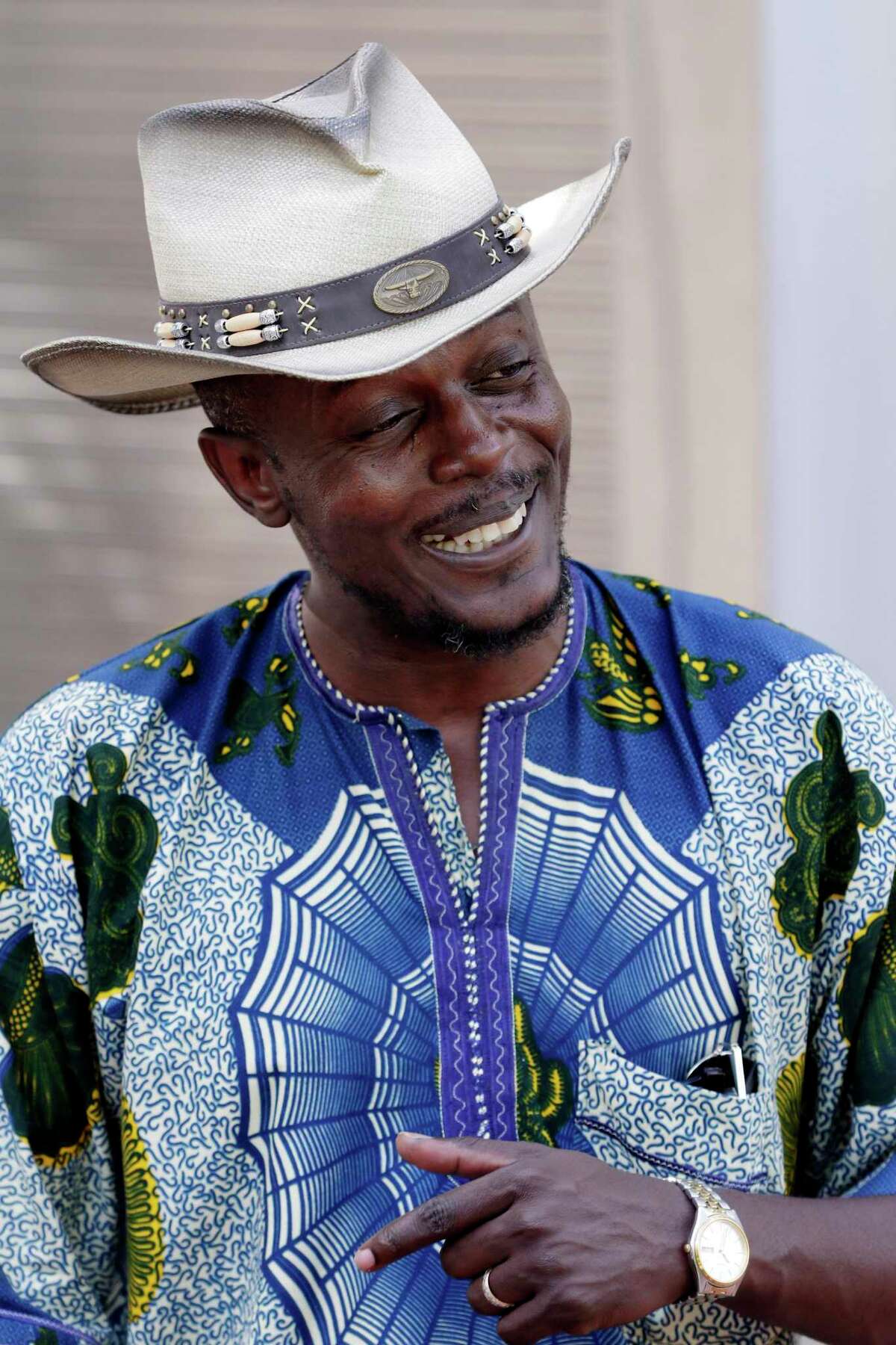A festival attendant wears a cowboy hat along with traditional Nigerian attire during the Nigerian Cultural Festival held in downtown Houston in September 2019. The metropolitan area is home to 35,000 Nigerians, the biggest population in the country after the New York- Newark- Jersey City area.