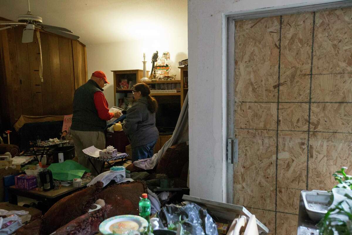 Homeowner Angeline Garza, 65, and State Farm Homeowners Claims Team Manager Dean Crane go over her insurance coverage and started claim process Wednesday, Jan. 29, 2020, at her damaged house in Houston. Garza's home, located on Stanford Court, was damaged in the Watson Grinding & Manufacturing explosion last week. Garza, her 41-year-old daughter and her two grandchildren will have to move to an apartment temporarily.