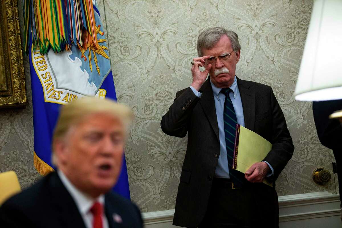 John Bolton, then the White House national security adviser, looks on as President Donald Trump speaks to reporters in the Oval office in 2018. A reader says no matter how much evidence there is against Trump, nothing will affect the president. Another reader wonders how senators might vote on impeachment if their votes were anonymous.