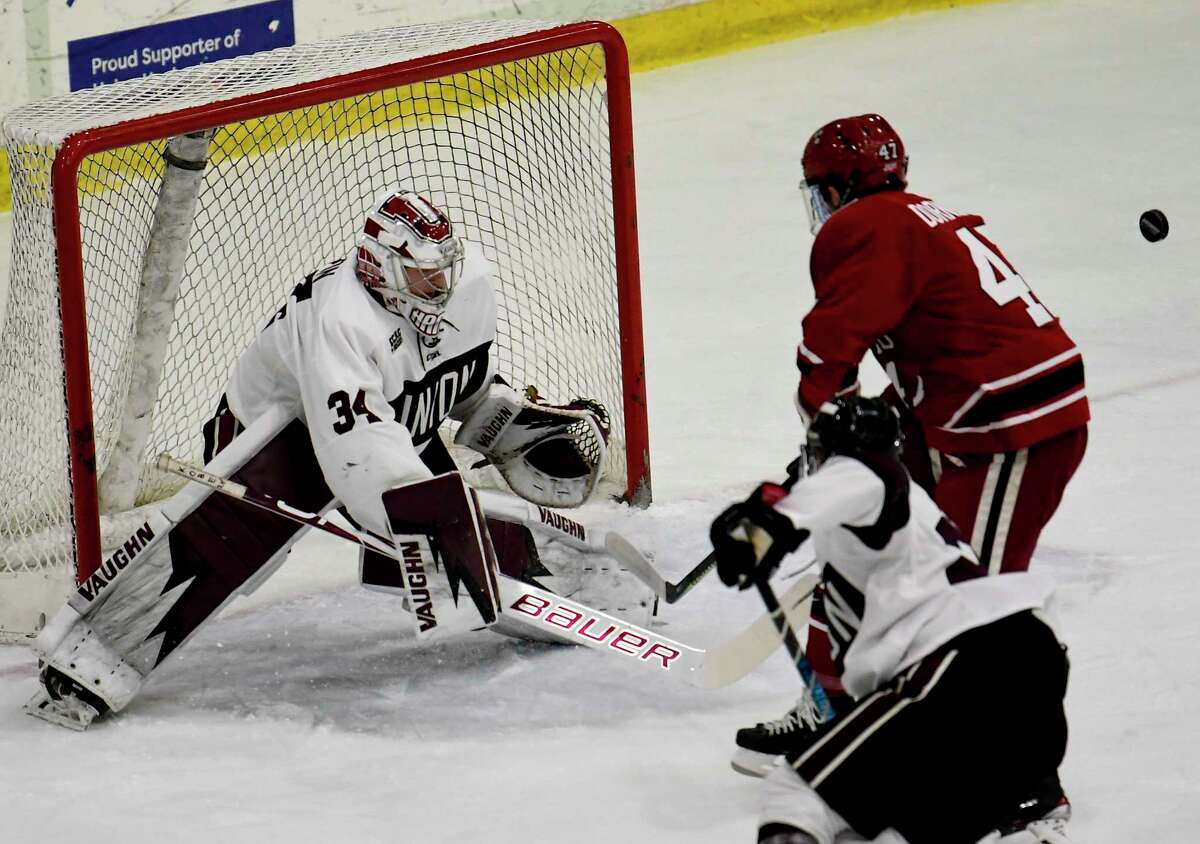 Union goaltender Darion Hanson (34) deflects a shot by Harvard forward Casey Dornbach (47) during the first period of an NCAA college hockey game Friday, Jan. 31, 2020, in Schenectady, N.Y.,