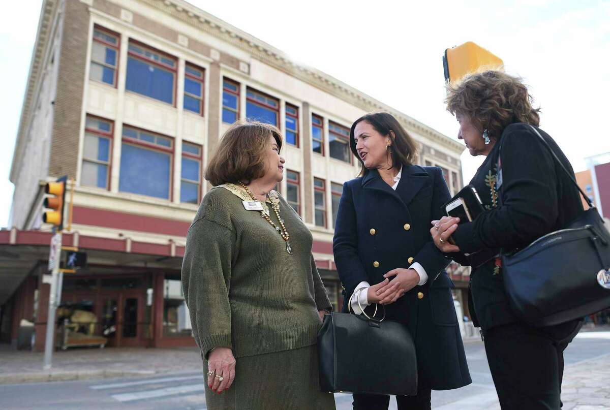 Bénédicte Montlaur, cneter, CEO of the World Monuments Fund, discusses with Virginia Van Cleave, left, and Rose Moran of The Conservation Society of San Antonio, her advocacy for preservation of the 1921 Woolworth Building because of its connection to the desegration of seven lunch counters in San Antonio during the civil rights era. The fate of the building, seen in the background, is in jeopardy; it could be demolished as part of the $450 million makeover of Alamo Plaza.