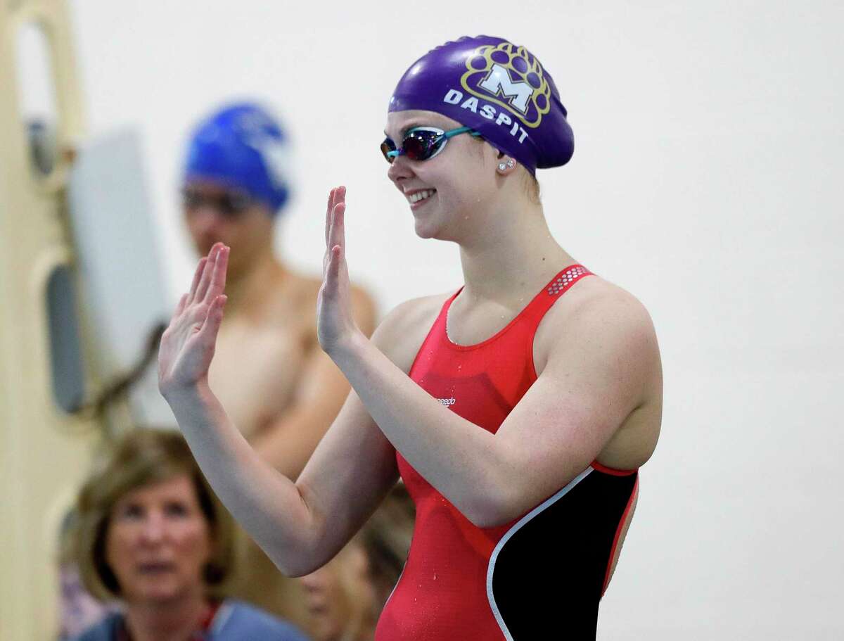 JoJo Daspit of Montgomery waves to fans before competing in the girls 50-yard freestyle during the Region VI-5A swimming championships at the Michael D. Holland Aquatic Center, Saturday, Feb. 1, 2020, in Magnolia.