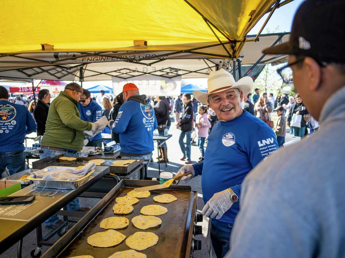 Robert Vasquez, 62, second right, works the tortilla skillet at the Legacy Engineering booth during the fourth annual Bexar County Rodeo Breakfast on the Southside of San Antonio, Texas on Saturday, February 1, 2020. This weekend kicks off the San Antonio Stock Show and Rodeo.