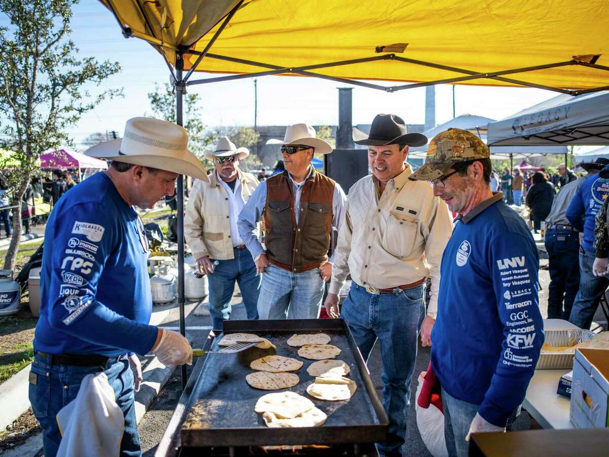 Ken Bukowski, 60, left, flips tortillas at the Legacy Engineering booth during the fourth annual Bexar County Rodeo Breakfast on the Southside of San Antonio, Texas on Saturday, February 1, 2020.