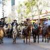 The 13th annual Western Heritage Parade and Cattle Drive makes its way through downtown.