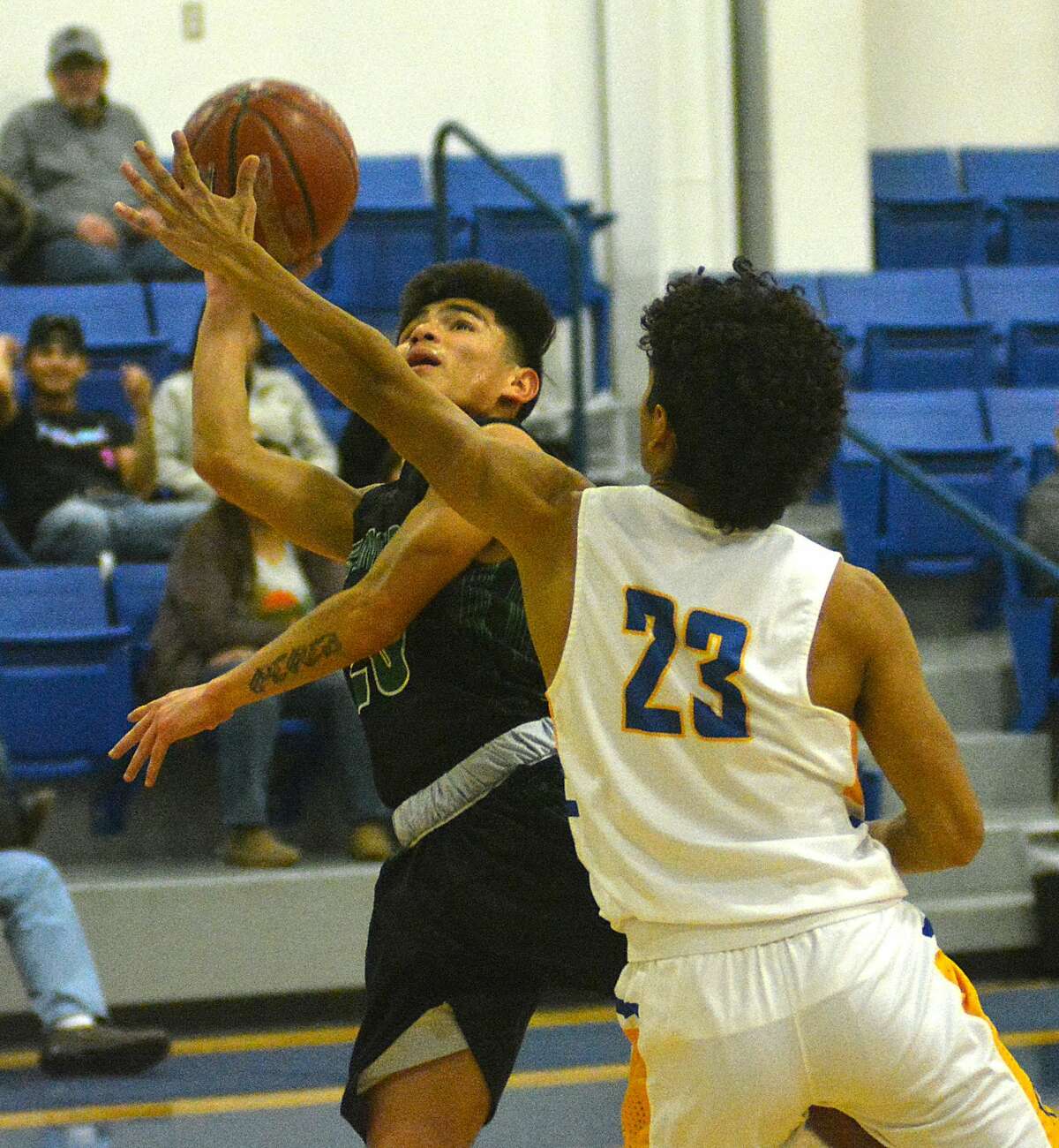 Floydada’s Marcus Perez puts up the shot attempt while being defended by Hale Center’s David Espinosa during their District 4-2A boys basketball game on Friday, Jan. 31, 2020 at Hale Center High School.