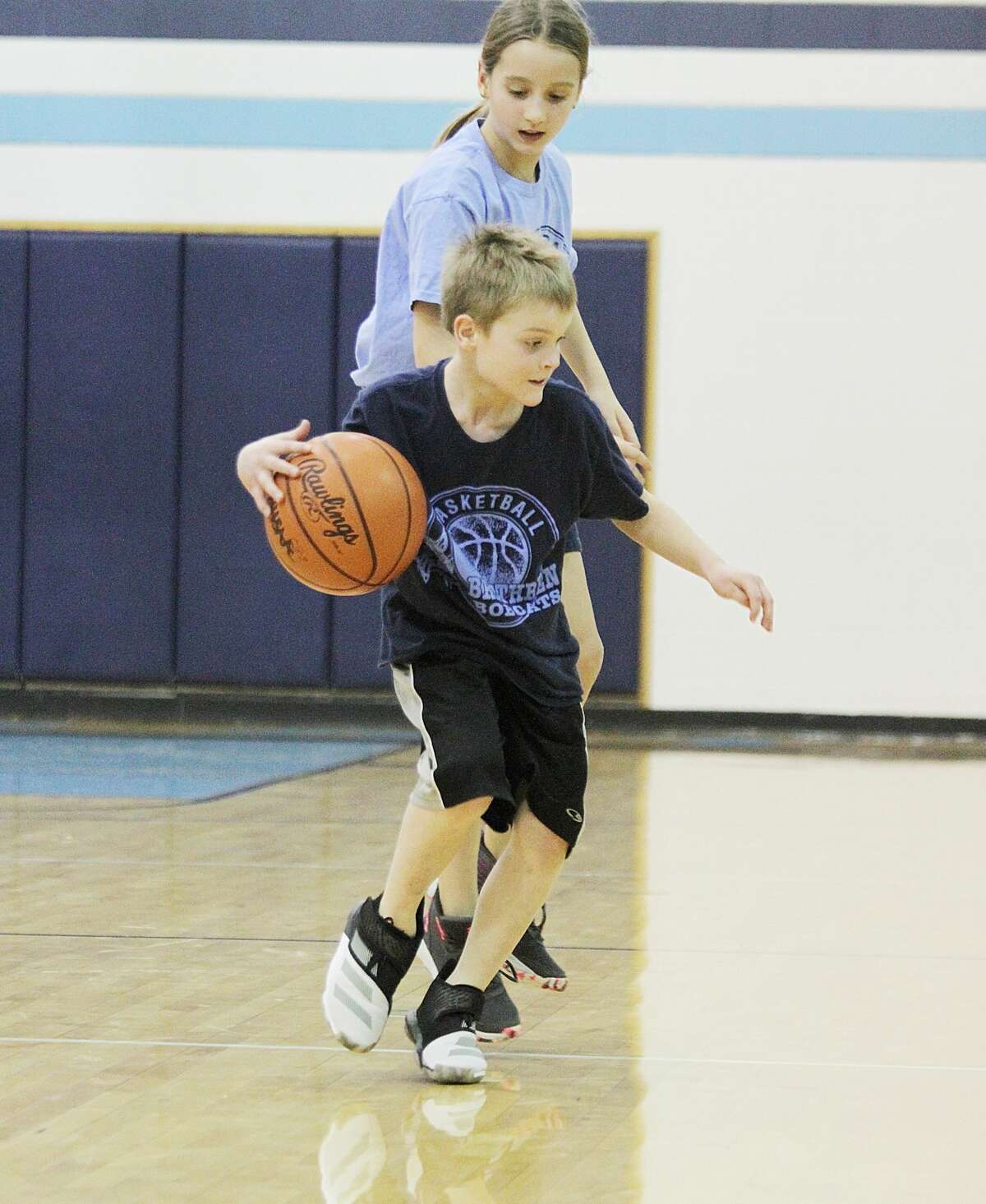 Ryder Girven is defended by Ava Seibert during a recent Brethren FUNdamentals youth game at halftime of the Bobcats' varsity contest.