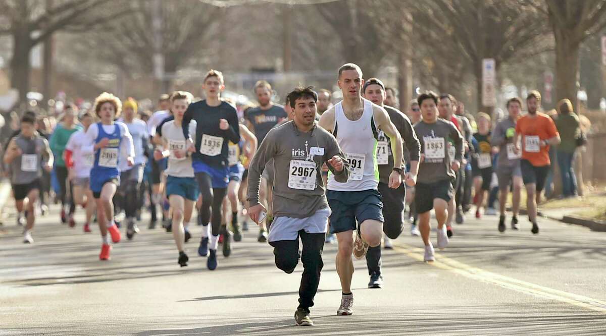 New Haven, Connecticut - February 02, 2020: Runners on Mitchell Drive at the start of the Run for the Refugees 5K road race and walk Sunday morning in New Haven that benefits IRIS (Integrated Refugee and Immigrant Services), starting and ending at Wilbur Cross High School.