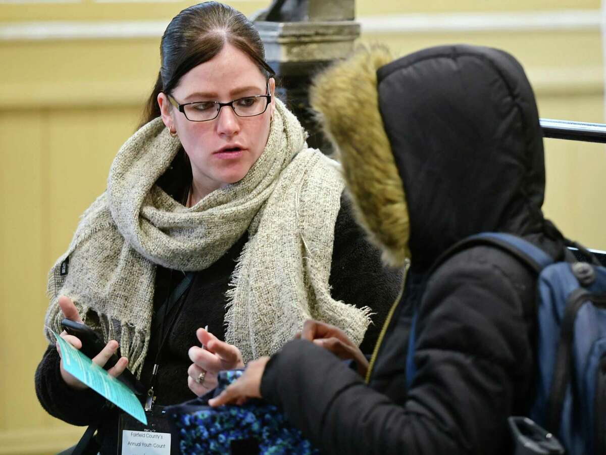 Case manager with the Connecticut Coalition to End Homelessness, Amber Hunter, asks youth to fill out a survey regarding their living situation at the South Norwalk Train Station Tuesday, January 28, 2019, in Norwalk, Conn. The Connecticut Coalition to End Homelessness looks to quantify the problem of youth homeless in Connecticut.