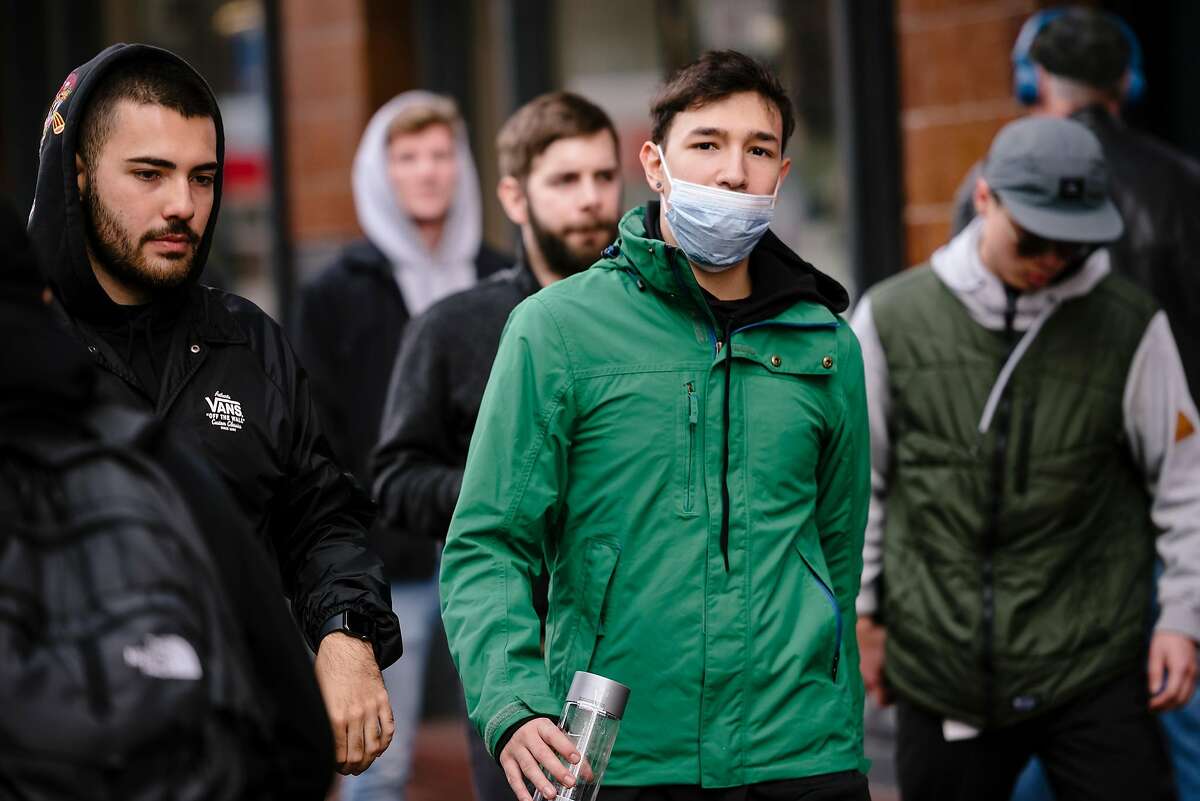 Brun Garcia, visiting from Brazil, wears a filter mask because he is sick and also because of fears over the coronavirus outbreak, in San Francisco, Calif, on Tuesday, January 28, 2020.