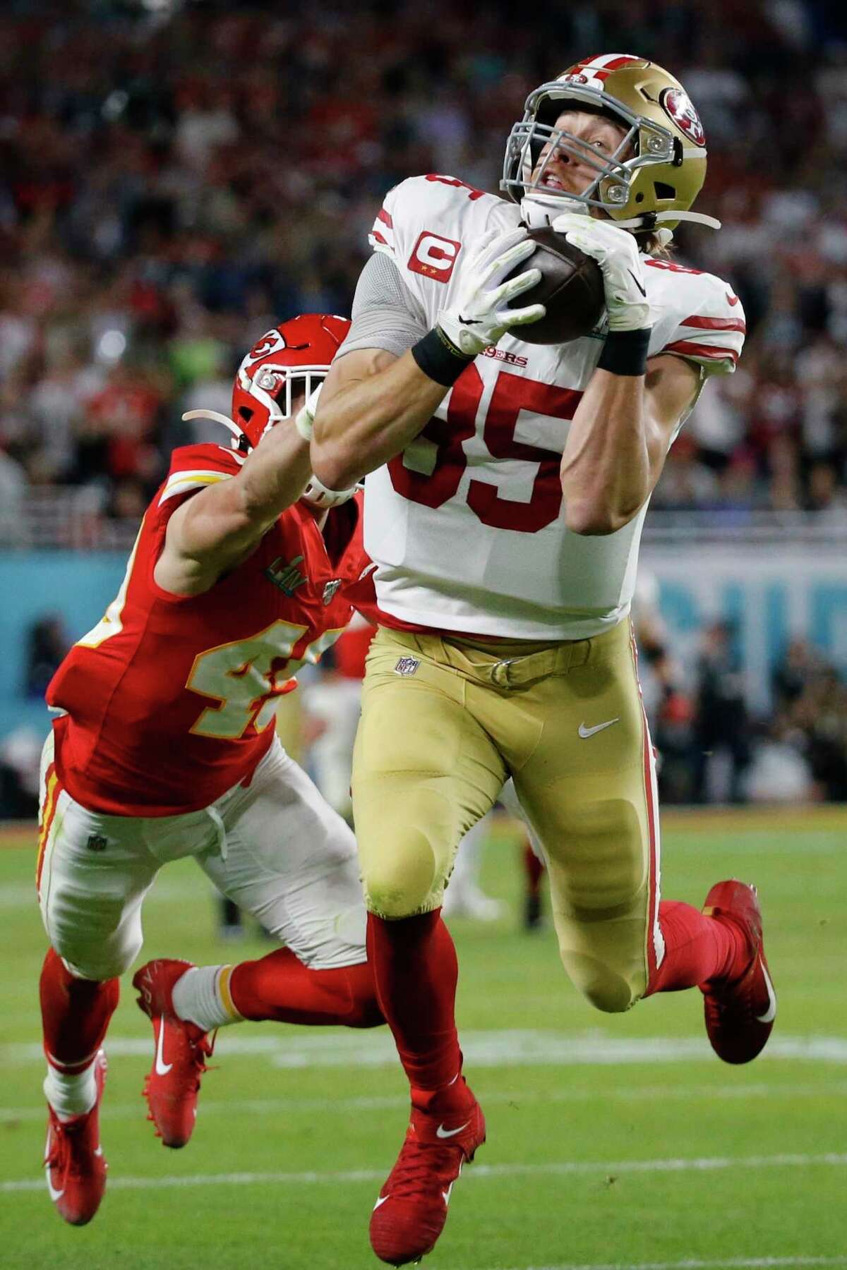 San Francisco 49ers' George Kittle (85) catches a pass in front of Kansas City Chiefs' Daniel Sorensen during the first half of the NFL Super Bowl 54 football game Sunday, Feb. 2, 2020, in Miami Gardens, Fla. The play was called back on a penalty by Kittle.