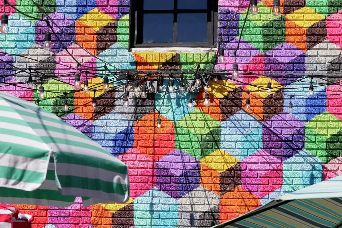 The wall mural of colored squares on the exterior walls of Present Company in Montrose. A Dallas muralist claims the mural on the side of club is a copy of his.
