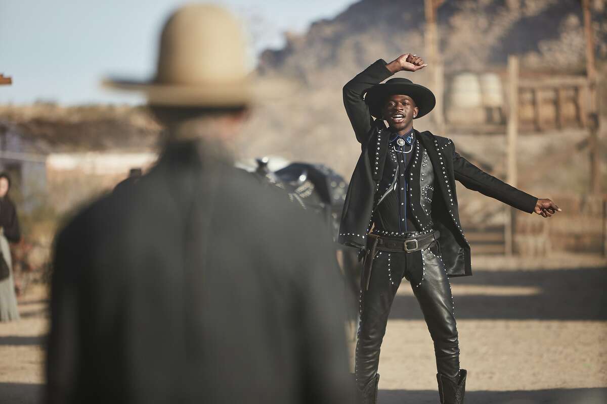 This undated photo provided by Doritos shows Lil Nas X, right, and Sam Elliott in a scene from the company's 2020 Super Bowl NFL football spot. The snack chip is betting people will connect with “Old Town Road,” the smash hit of the summer by Lil Nas X.(Doritos via AP)