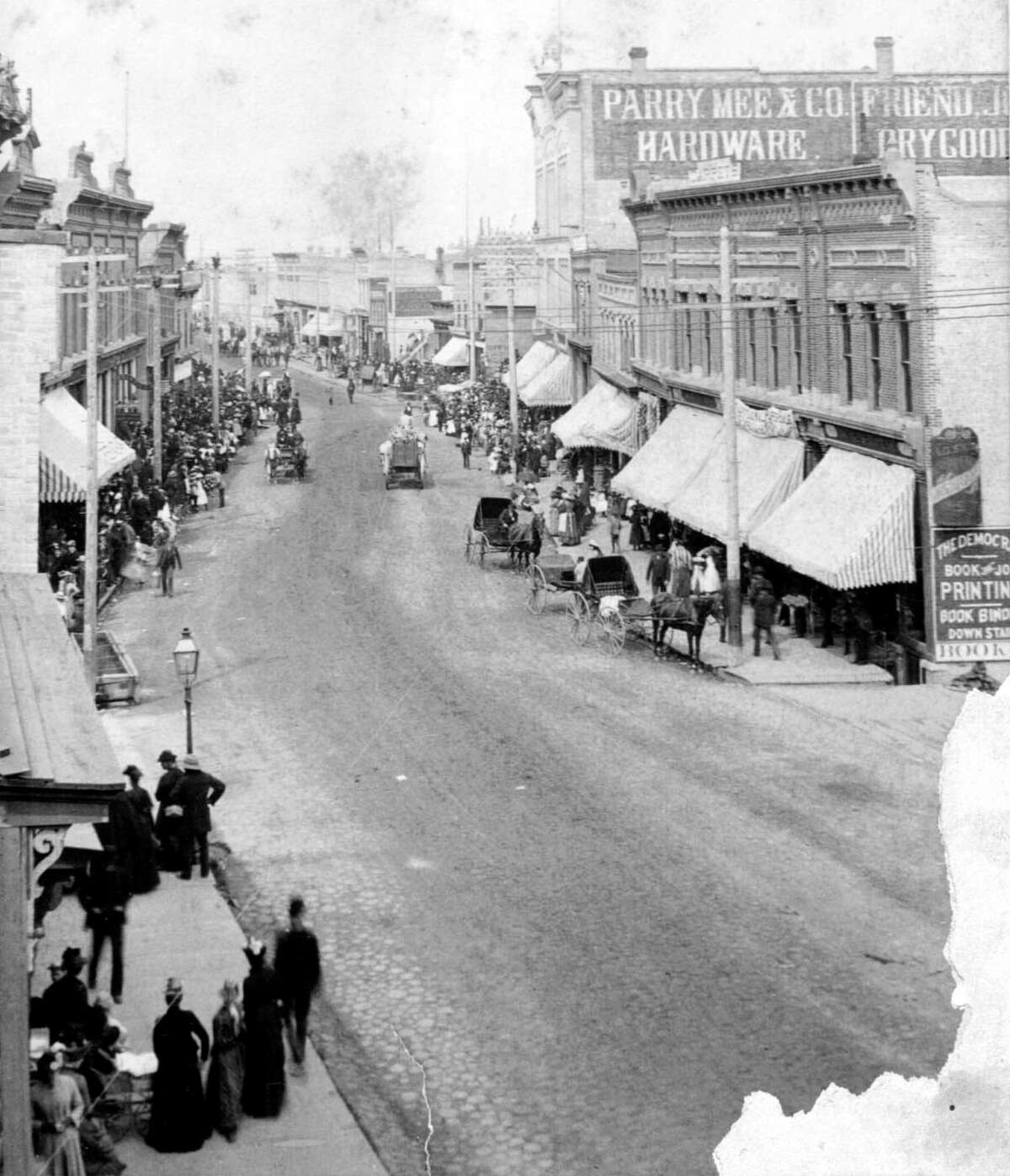 The Manistee River Street area slightly resembles the street that exists today in this 1890s photograph.