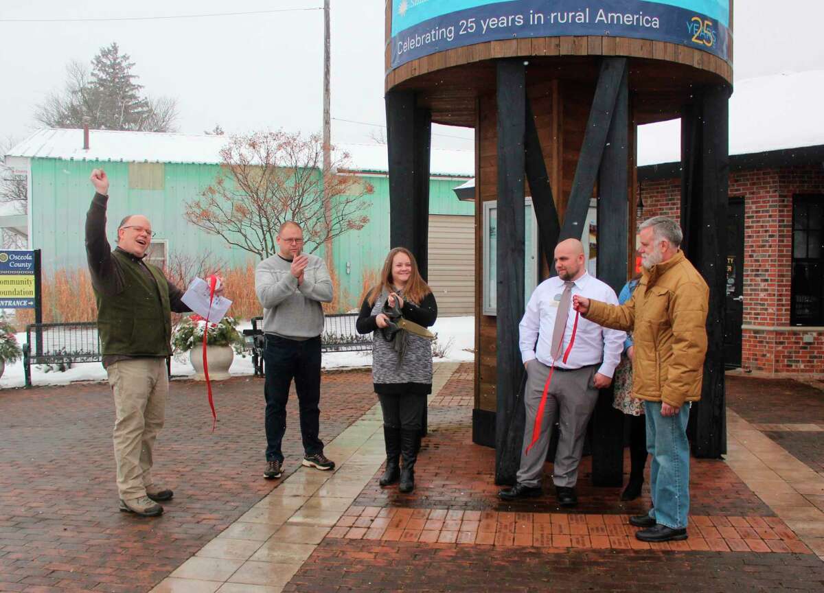 Residents and guests of Reed City attended a ribbon cutting ceremony for "Crossroads: Change in Rural America" on Saturday. The exhibit is part of the Smithsonian Museums on Main Street project and will be on display at the depot in Reed City until March 15. (Herald Review photo/Taylor Fussman)