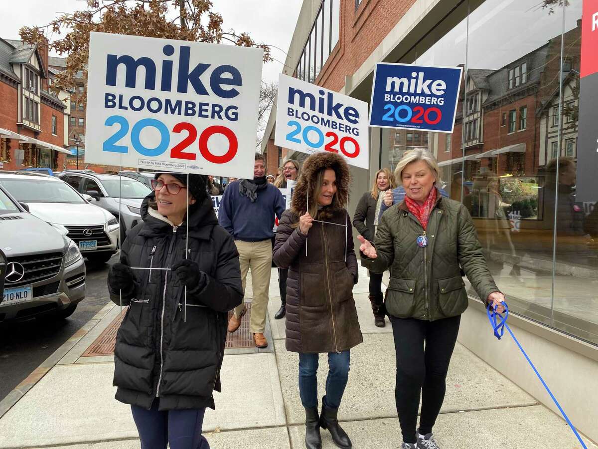 Volunteers with the Mike Bloomberg for president campaign canvass in downtown Greenwich, holding lawn signs and signing up residents to get involved with the campaign