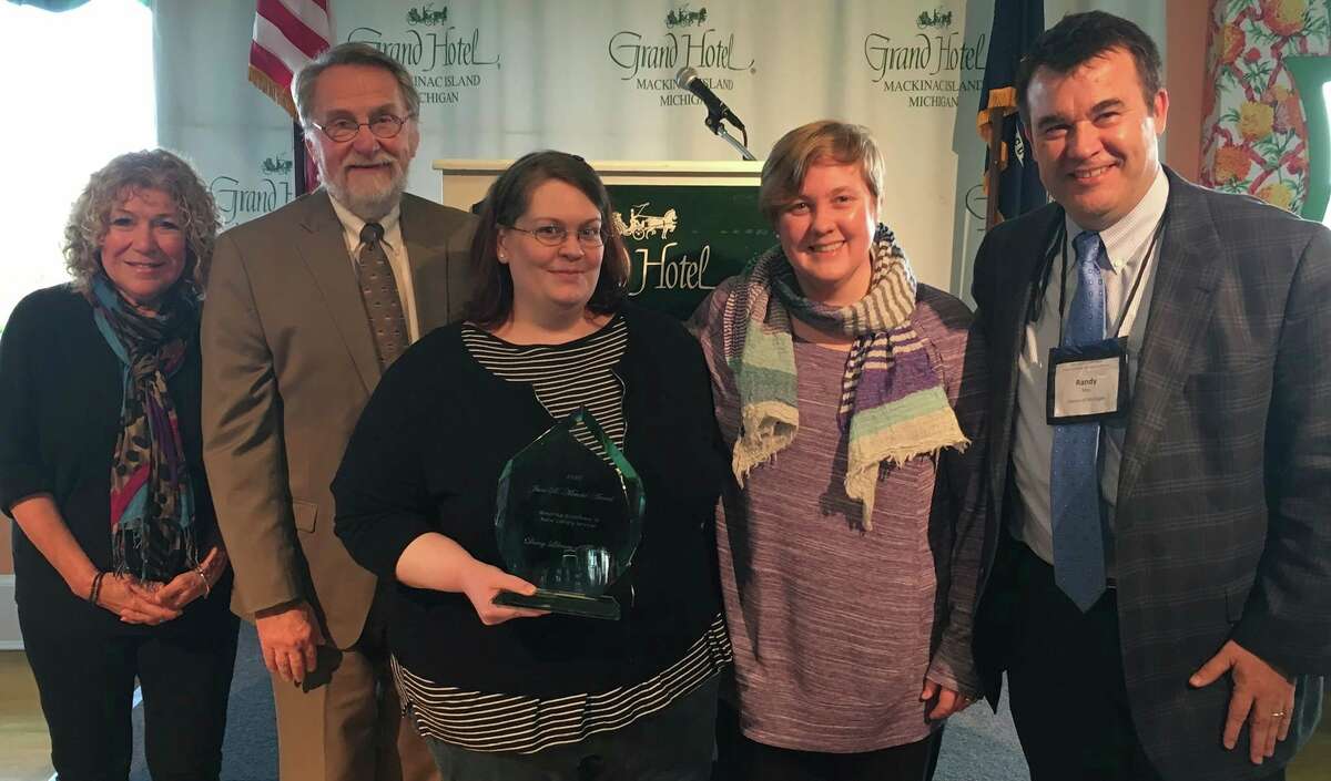 Heather Doran (center) along with former colleague, Ashley Olstad, accept the June B. Mendel Award from the Library of Michigan for Excellence in Rural Library Service in 2016. Doran has established the Michigan Literary Arts Association (MLAA) to support and advance female authors. (Courtesy Photo)