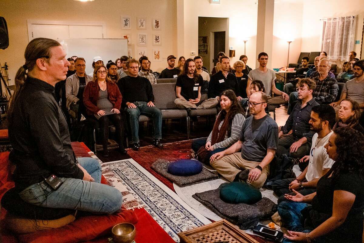 Michael Taft, a teacher at SF Dharma Collective, leads a meditation before an event at the collective.