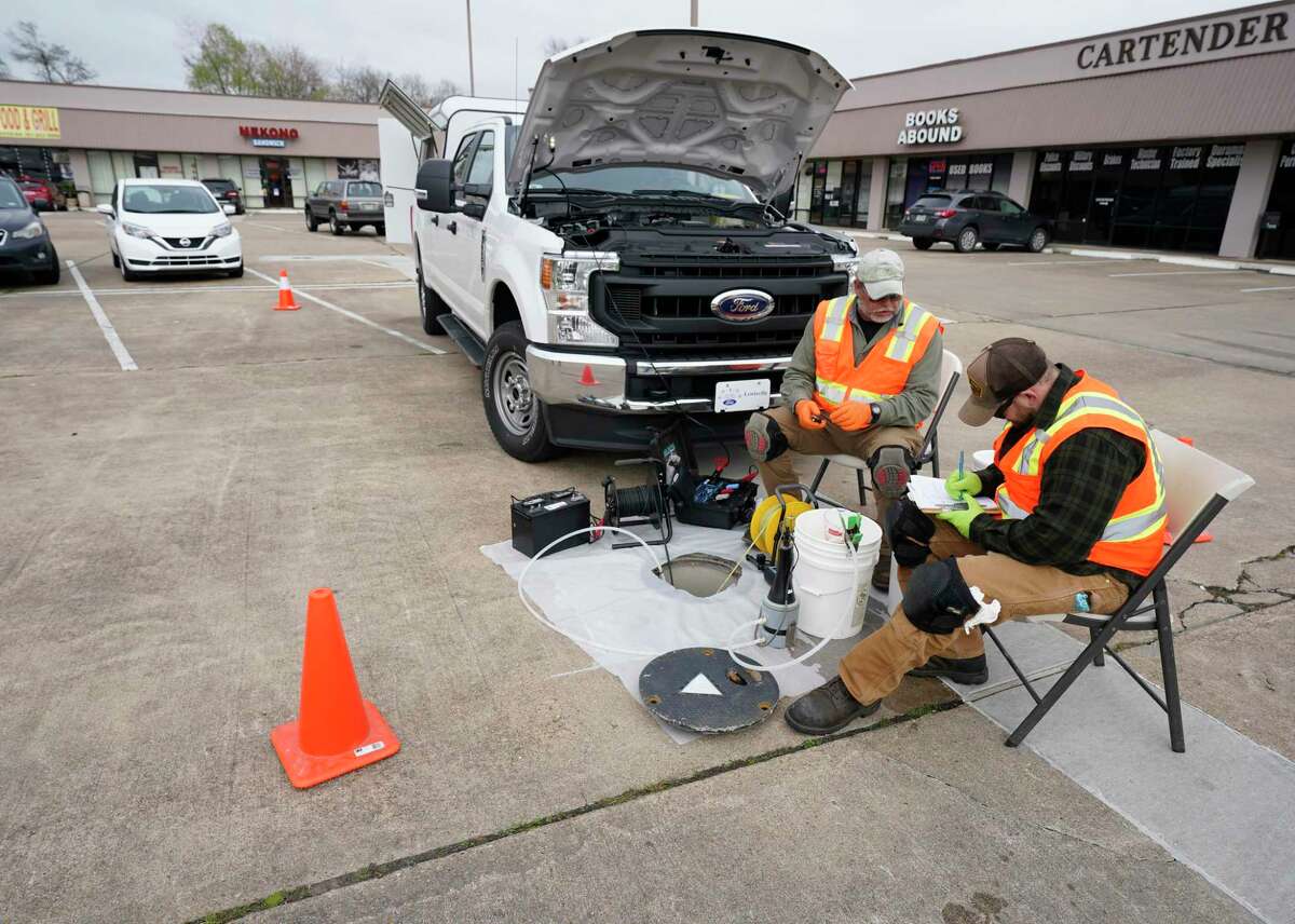 EPA contractors in the parking lot of Cypress Centre, 11600 Jones Road, conduct testing at the Jones Road Ground Water Plume Superfund Site Wednesday, Jan. 29, 2020, in Houston. The area was contaminated with tetrachloroethylene from the former Bell Dry Cleaners located at the shopping center.