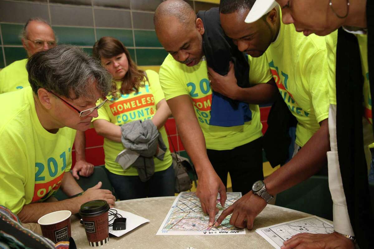 A team of volunteers study the map of the area they are going to cover for the annual Houston homeless count in 2017.
