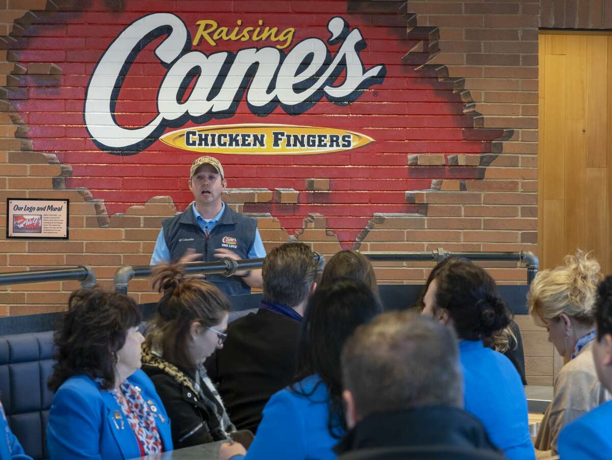Mike Spano, area leader of restaurants for Raising Cane's, tells about the history of the restaurant 02/04/20 morning at the grand opening of Midland's Raising Cane's. Tim Fischer/Reporter-Telegram