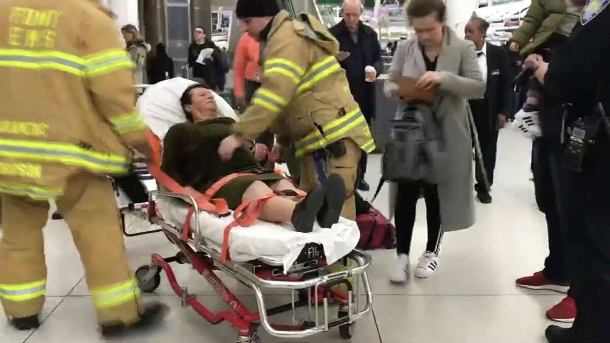 In this still image taken from video provided by WNBC-TV News 4 New York, emergency medical personnel tend to an injured passenger from a Turkish Airlines flight at New York's John F. Kennedy International Airport, Saturday, March 9, 2019. Officials say severe turbulence injured at least 30 people aboard a Turkish Airlines flight from Istanbul that landed safely at New York's Kennedy International Airport.