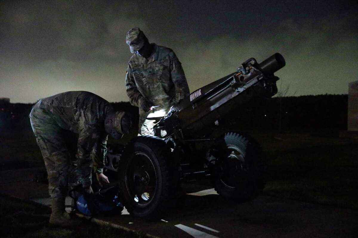 Spec. Joshua Torres, left, and Sgt. Alvin Dorsey load a blank round into a 75mm Pack Howitzer before reveille at Joint Base San Antonio-Fort Sam Houston.