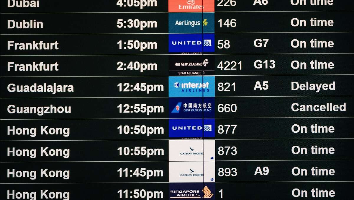 A flight departure board showing a flight to Guangzhou China as canceled is seen on the International departures level at San Francisco International Airport in San Francisco, Calif. on Tuesday, February 4, 2020.