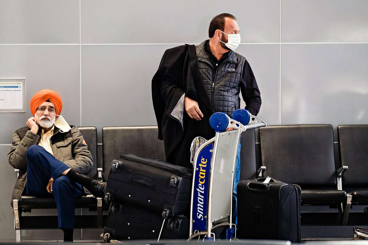 Passengers are seen wearing masks as they wait for their flight to India at International departures level at San Francisco International Airport in San Francisco, Calif. on Tuesday, February 4, 2020.