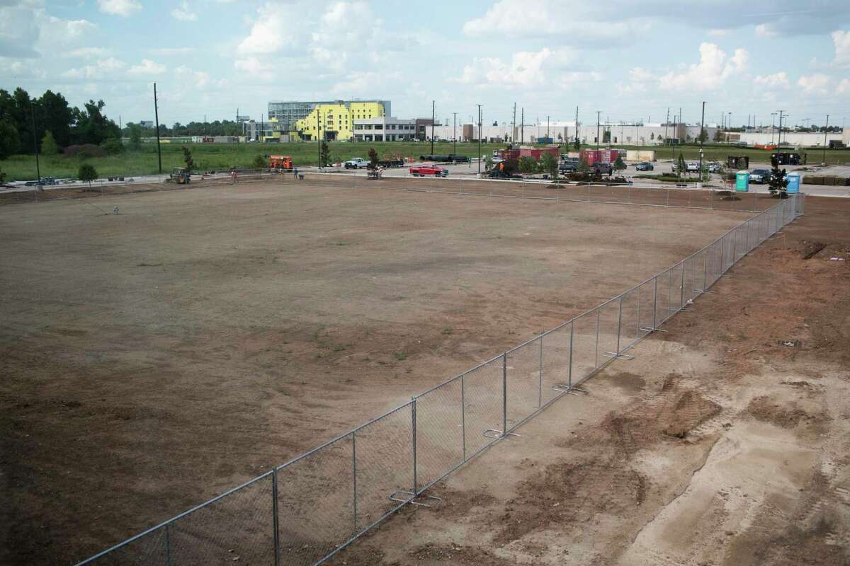 View of a burial site surrounded by a fence from the second floor of the nearly finished James Reese Career and Technical Center on Tuesday, Sept. 3, 2019 in Sugar Land. The burial site contained the remains of 95 black prison laborers forced to work. The remains were later reinterred.