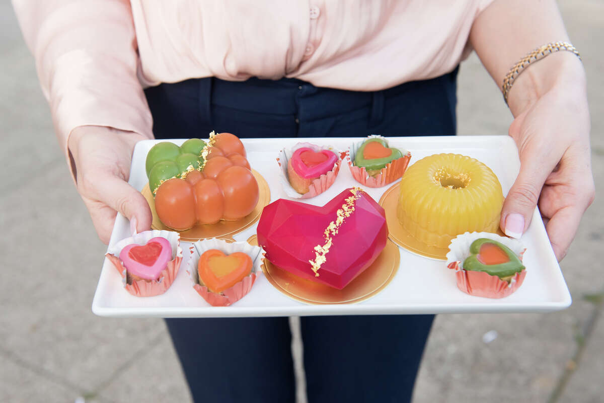 Olia Rosenblatt shows us an assortment of cakes in front of her boutique storefront.