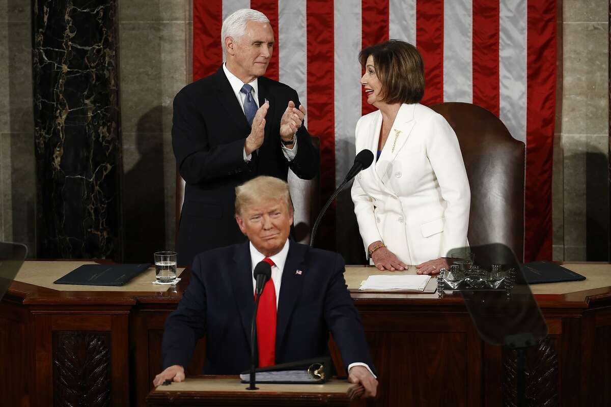 President Donald Trump arrives to deliver his State of the Union address to a joint session of Congress on Capitol Hill in Washington, Tuesday, Feb. 4, 2020., House Speaker Nancy Pelosi of Calif., smiles at Vice President Mike Pence. (AP Photo/Patrick Semansky)