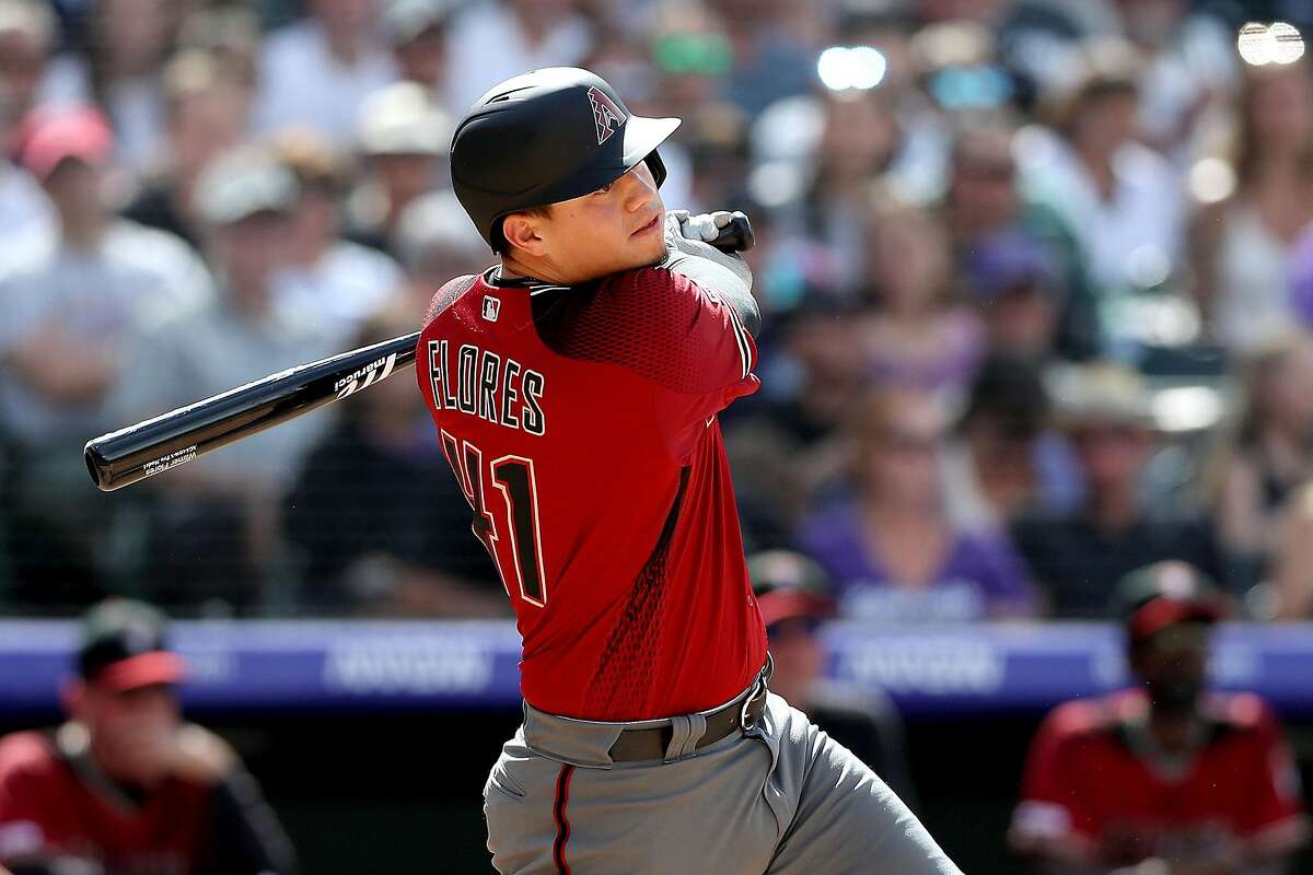 DENVER, COLORADO - MAY 05: Wilmer Flores #41 of the Arizona Diamondbacks hits a RBI single in the eighth inning aganst the Colorado Rockies at Coors Field on May 05, 2019 in Denver, Colorado. ~~