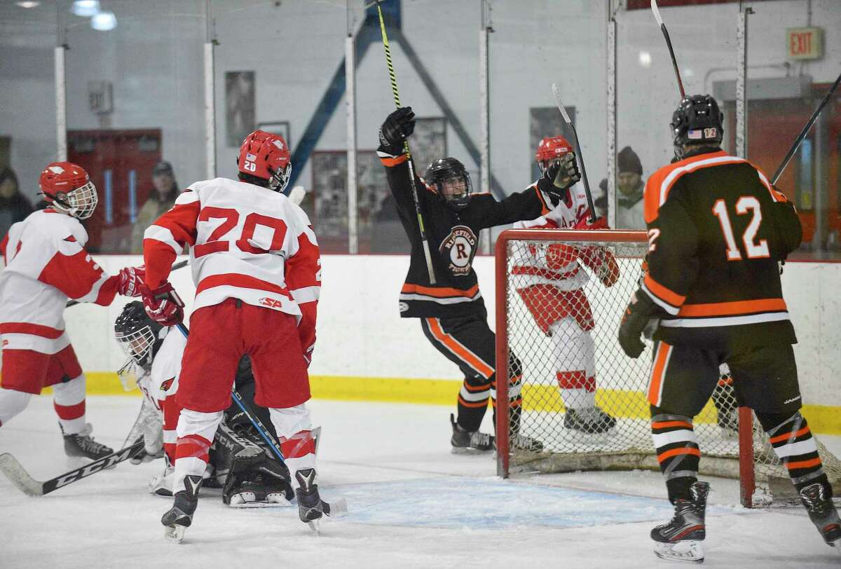 Ridgefield's William Stewart (17) celebrates his goal on Greenwich goalie Ben Nash in the first period to tie up the game 1-1 in an FCIAC boys hockey game at Hamill Rink in Greenwich, Conn. on Feb. 4, 2020. Greenwich won 2-1.