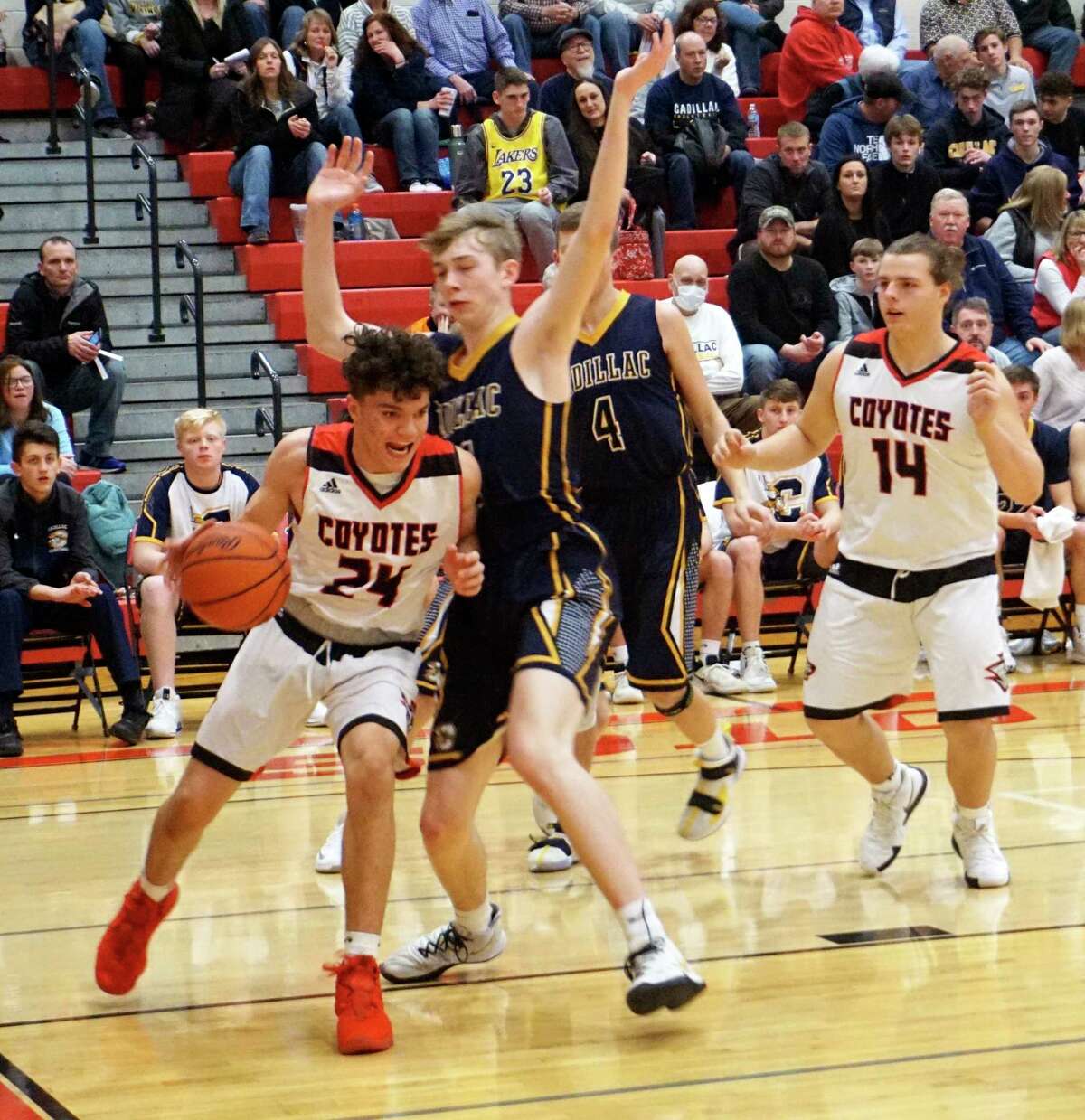 Reed City freshman Xavier Allen battles to stay inbounds along the baseline during the Coyotes' 76-34 loss to Cadillac on Jan. 29 at RCHS. (Herald file photo/Joe Judd)