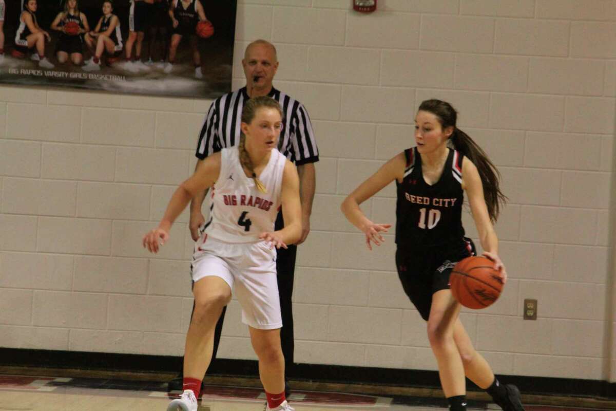 Reed City's Mackenzie Vandawater (10) looks to make a move on Big Rapids' Holly McKenna during recent action. (Herald photo/John Raffel)