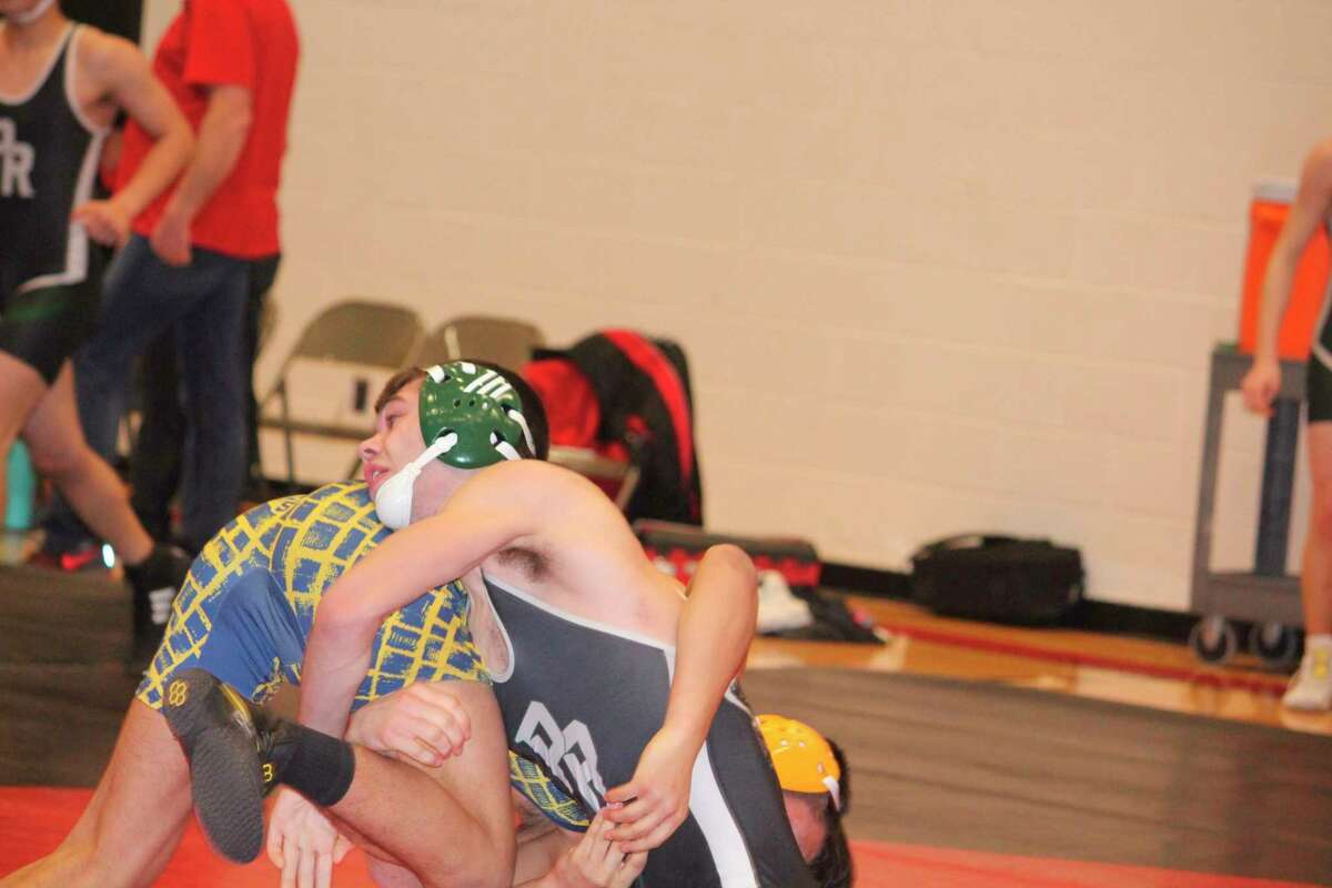 Pine River's Jordan Koetje (right) looks to make a move against his opponent on Saturday at Reed City. (Herald Review photo/John Raffel)