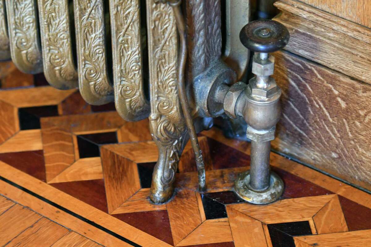 Radiator and inlaid floor detail inside Karin Krasevac-Lenz's Second Street home on Tuesday, Feb. 4, 2020, in Troy, N.Y. The Hart Cluett Museum executive director hopes her home will be featured in a new HBO production titled "The Gilded Age," written by the writer for "Downton Abbey." Filming is slated for June. (Will Waldron/Times Union)