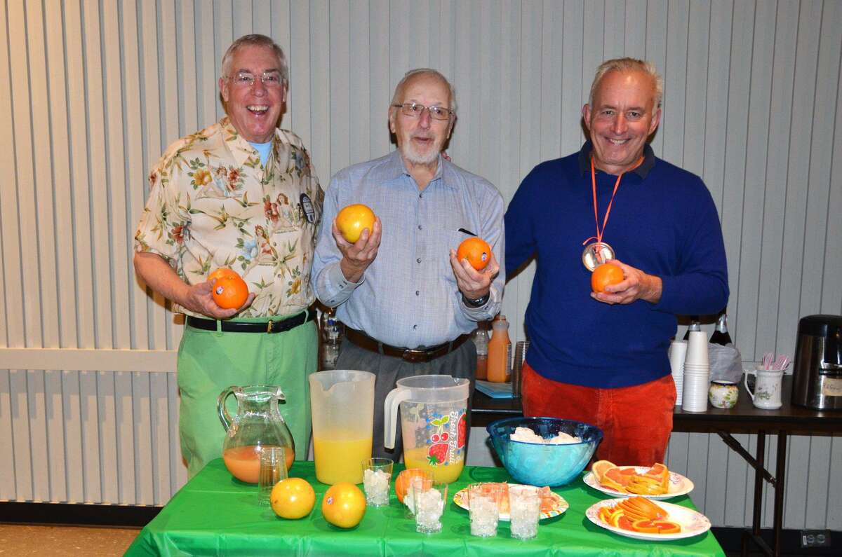 Kiwanians Marty Clancy, left, Bud Taylor and Mike Safko demonstrate some ways to use the juice of the oranges and grapefruits the club is offering in their annual fundraiser - mimosas, screwdrivers and more.