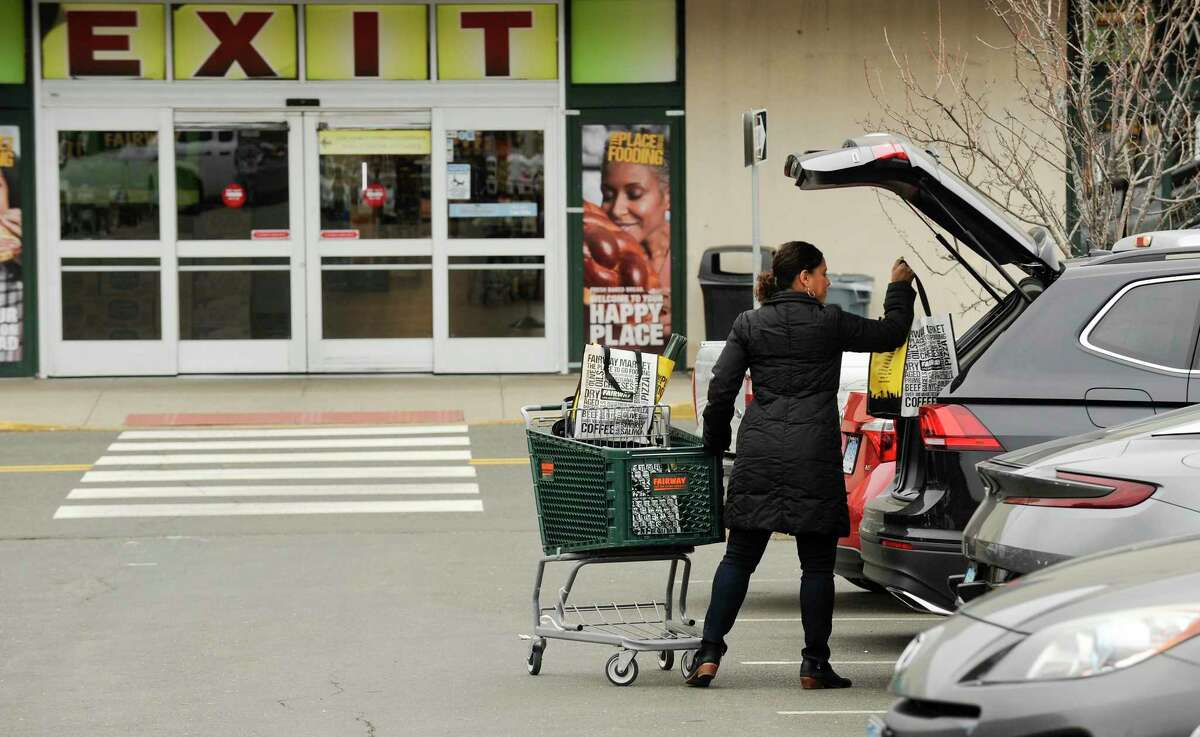 Rachel Hughes of Stamford places her bags of groceries in her car after shopping at Fairway Market at 699 Canal St., in Stamford, Conn., on Feb. 5, 2020. Fairway Market could close its Stamford store and lay off about 150 employees, if it does not receive an offer to buy the store, according to a letter to the state DOL.