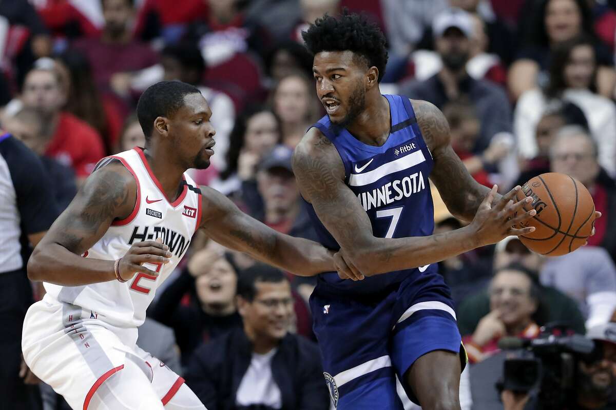 Minnesota Timberwolves forward Jordan Bell (7) looks to drive around Houston Rockets guard Michael Frazier, left, during the second half of an NBA basketball game Saturday, Jan. 11, 2020, in Houston. (AP Photo/Michael Wyke)