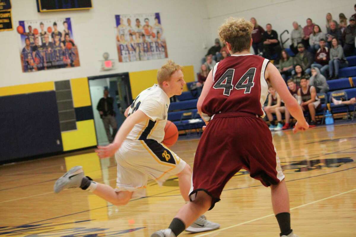 Baldwin's Jesse Pancio (left) takes the ball up court against Marion on Thursday. (Star photo/John Raffel)