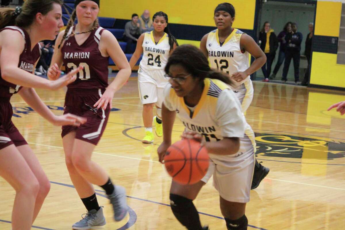 Baldwin's Kendra Washington dribbles against the Baldwin defense Thursday. (Star photo/John Raffel)